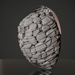 Huum Drop 9KW sauna heater add-on with polished chrome cage, filled with gray sauna stones.
