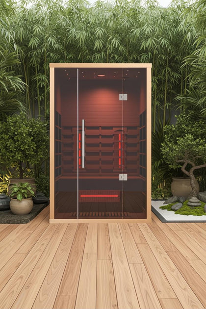 Lumin Infrared Sauna Two with light wood frame, glass door, and red interior heaters on a wooden deck.