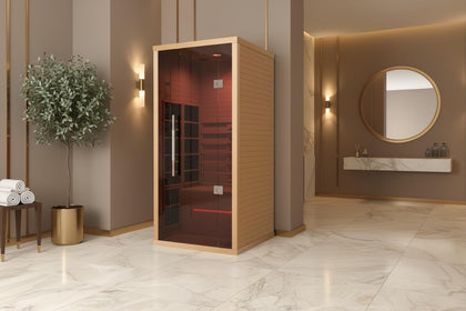 Lumin One compact 1-2 person infrared sauna made of light Canadian Hemlock with a dark red glass door.