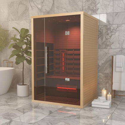 Lumin Infrared Sauna Two with light wood exterior, glass door, and red interior lighting in a modern bathroom.