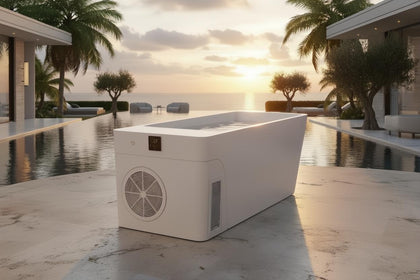 White modern Frost Cold Plunge Tub with digital display, fan, and side vent, by an infinity pool at sunset.