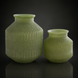 Set of two green marbled glass decorative accents with textured sculptural forms.
