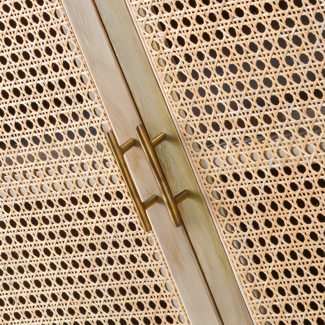 Close-up of a modern Surya Etewah sideboard with natural rattan doors, mango wood trim, and brass handles.