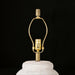 Surya Capelli accent table lamp base with a white ceramic body and gold-tone metal harp.
