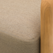 Close-up of a Surya Palma Swivel Chair with a beige Sunbrella® acrylic cushion and natural teak wood arm.