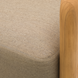 Close-up of a Surya Palma Swivel Chair with a beige Sunbrella® acrylic cushion and natural teak wood arm.