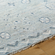 Hand-knotted Surya Almeria ALM2302 low pile area rug in multi-tone Denim, Black, Dusty Sage, Light Beige, Cream, Burgundy with fringe.