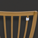 Close-up of a wheat-finished Surya Cape Town outdoor dining chair back with vertical slats and a white tag.