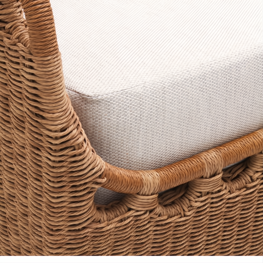 Close-up of Marvella Sectional's woven brown wicker frame and light beige Sunbrella cushion.
