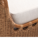 Close-up of Marvella Sectional's woven brown wicker frame and light beige Sunbrella cushion.