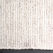 Close-up of a Surya Azalea AZA-2326 handmade rug, showing its light beige, black, and gray woven recycled PET yarn texture.