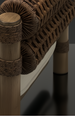Close-up of Surya Porta outdoor accent chair with brown wicker, aluminum frame, and quick-dry cushion.
