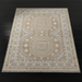 Hand-knotted Surya Almeria rug with mustard, gray, blue, beige, cream, and black geometric patterns.