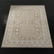 Hand-knotted Surya Almeria rug with mustard, gray, blue, beige, cream, and black geometric patterns.