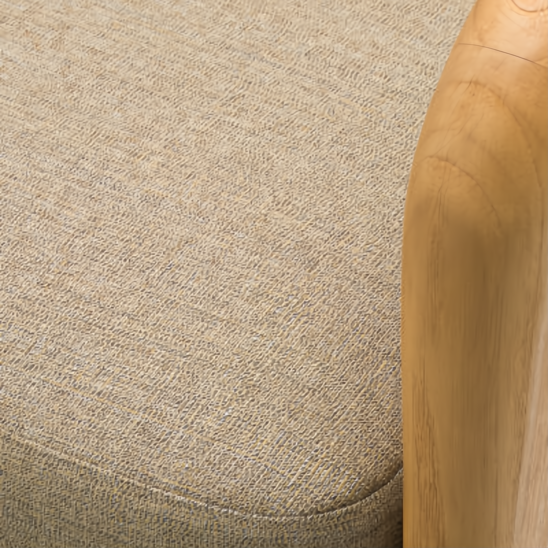Close-up of Surya Palma Dining Chair: taupe Sunbrella acrylic upholstery and light teak wood arm.