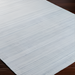 Light gray Surya Fresno area rug with subtle striped texture on dark wood floor.