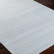 Light gray Surya Fresno area rug with subtle striped texture on dark wood floor.