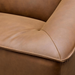 Close-up of a brown leather Surya Alba sofa with cushioned seating and refined piping.