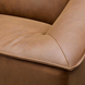 Close-up of a brown leather Surya Alba sofa with cushioned seating and refined piping.