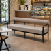 Surya Antibes Sofa with brown and beige stripes, black aluminum base, and channel stitch detail in a cafe setting.