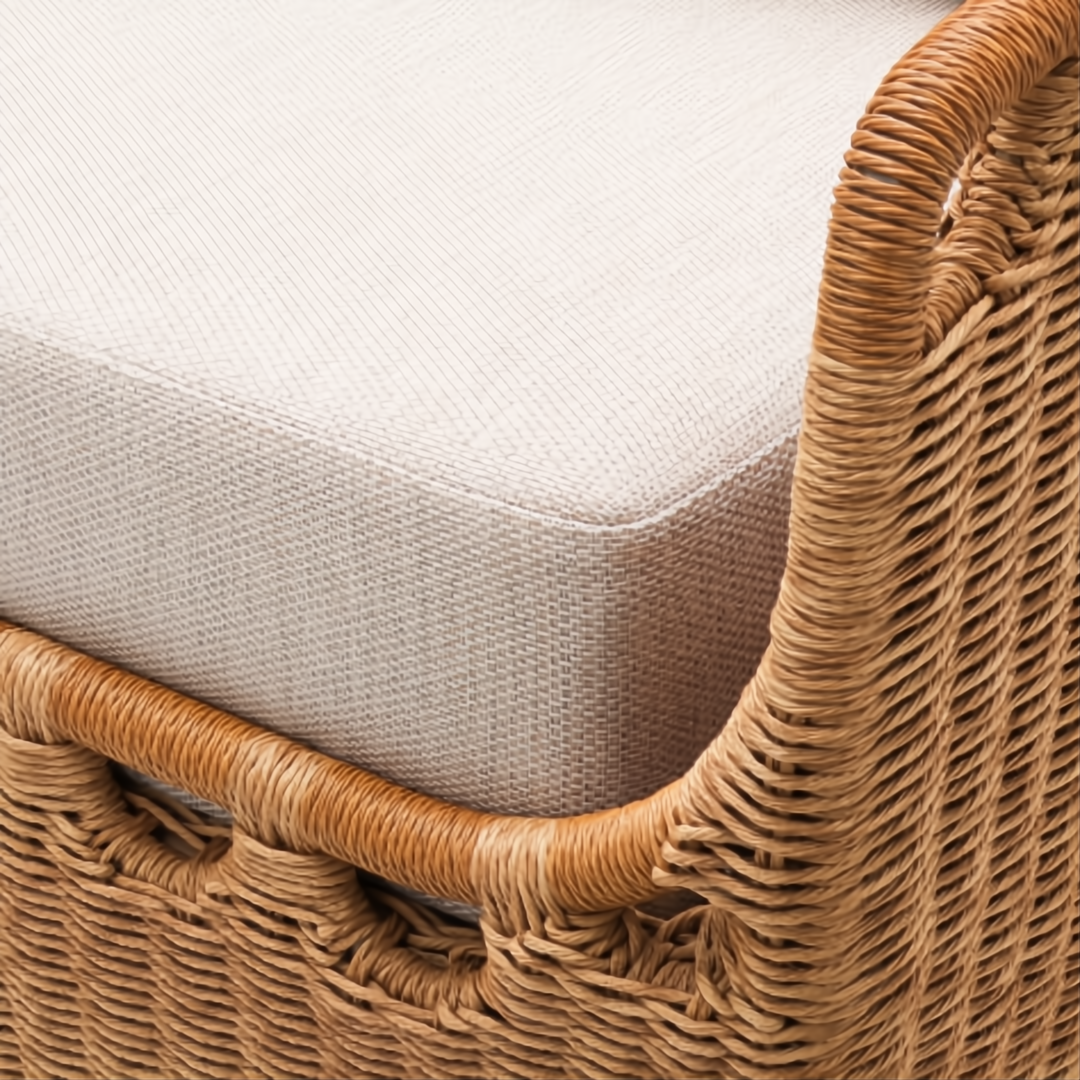 Close-up of a Marvella sectional right arm, featuring natural woven wicker and a light beige Sunbrella cushion.