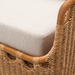 Close-up of a Marvella sectional right arm, featuring natural woven wicker and a light beige Sunbrella cushion.