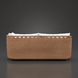 Marvella outdoor sectional with light brown woven base and white cushions.