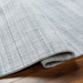 Light blue Surya Fresno FNO2304 area rug, hand-loomed from recycled PET yarn, with subtle striped texture.