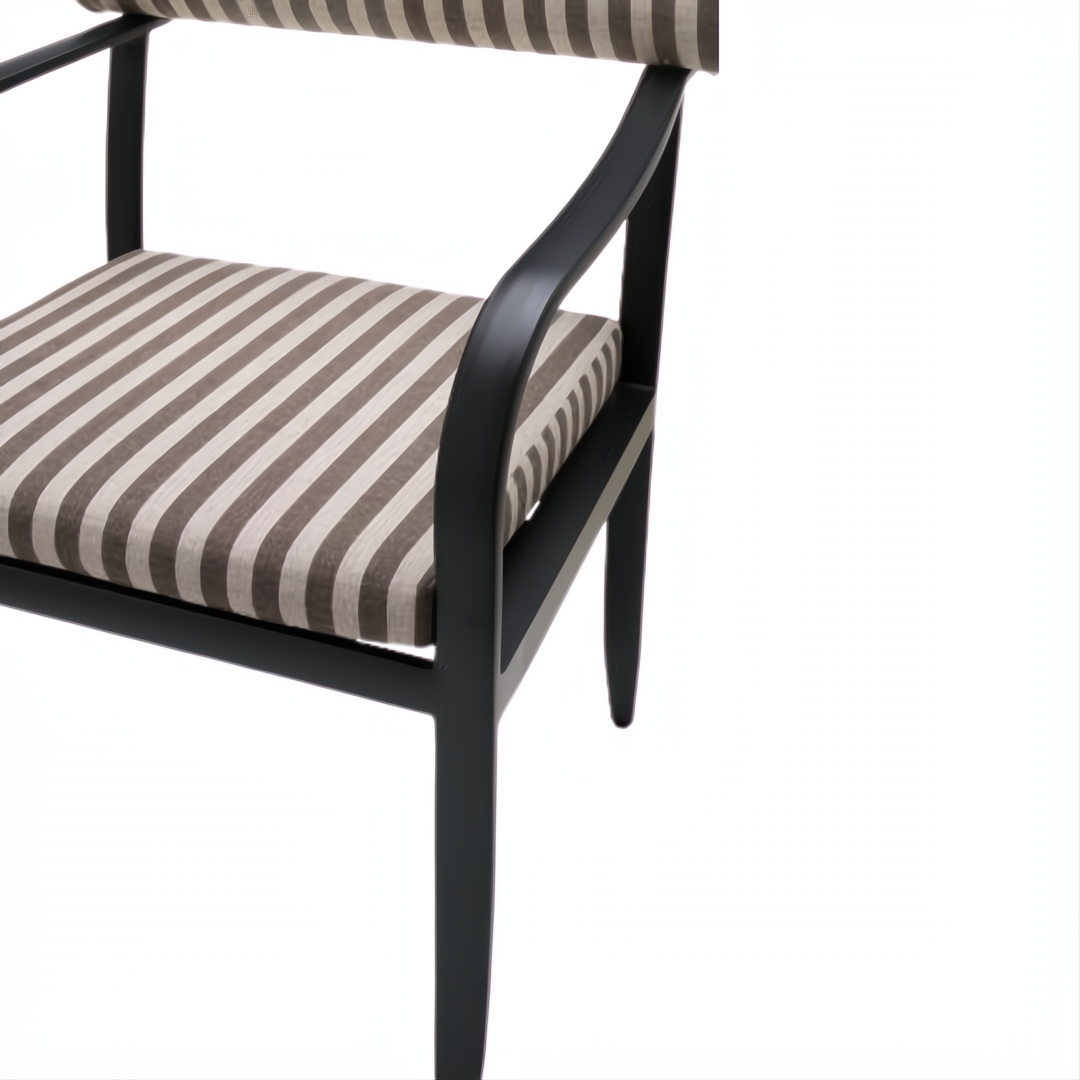 Surya Antibes dining arm chair with multi-color striped Sunbrella upholstery and black aluminum frame.