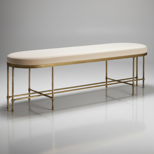Surya Engel bench with a long, cream polyester cushion and a metallic brass iron base.