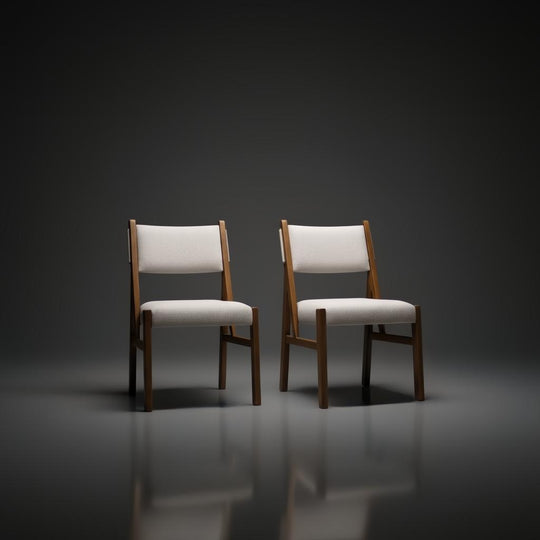 Two Surya Bergene dining chairs with light beige upholstery and brown rubber wood frames.