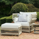 Cream Surya Winder accent chair with Sunbrella cushions, matching ottoman, and side table on a patio.