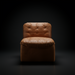 Surya Oryan RYAN-001 modular chair with brown tufted leather upholstery and a black base.