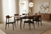 Surya Billings Dining Chairs with black faux leather and wood veneer, surrounding a dining table.