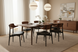 Surya Billings Dining Chairs with black faux leather and wood veneer, surrounding a dining table.