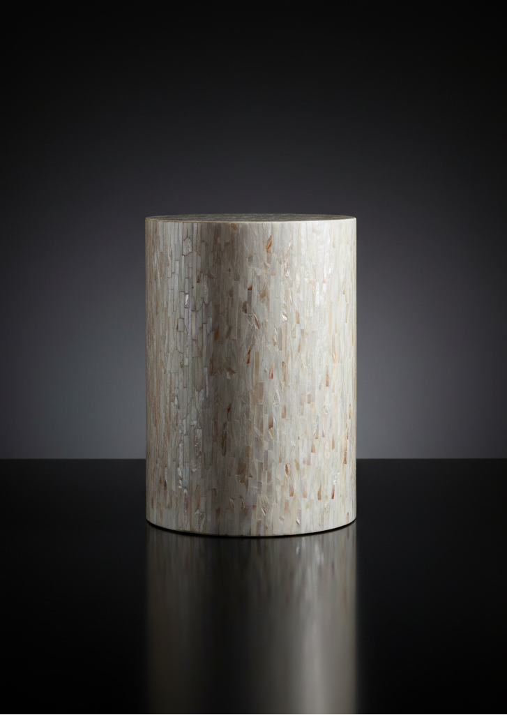 Round Surya Iridescent End Table with tan and ivory shell detailing, crafted from shell and manufactured wood.