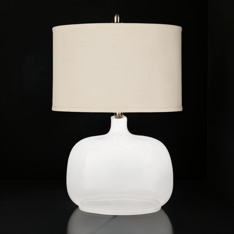 Surya Bentley accent table lamp with a white glass base and a cream fabric drum shade.
