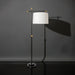 Modern black and gold sculptural floor lamp with an ivory linen shade, casting a soft glow.