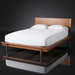 Grande King/CA King wood bed with a minimalist modern design and brown poplar finish.