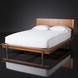 Grande King/CA King wood bed with a minimalist modern design and brown poplar finish.