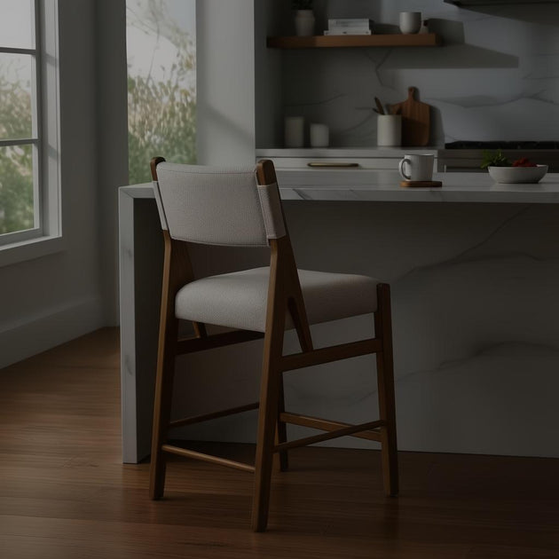 Surya Bergene light beige upholstered counter stool with a brown natural rubber wood frame.