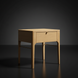 Light brown oak veneer end table with a single drawer, rounded edges, and metallic brass accents.