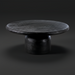 Black sandblasted mango wood Koben coffee table with a round top and turned base, showcasing exposed wood grain.