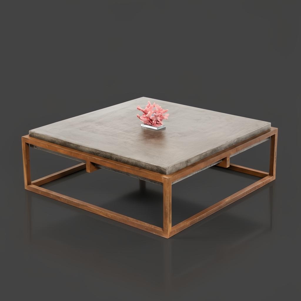 Industrial-modern square concrete coffee table with a sleek bronze metal frame, featuring a coral accent.