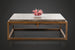 Industrial-modern concrete coffee table with a sleek metal frame, topped with pink coral decor.