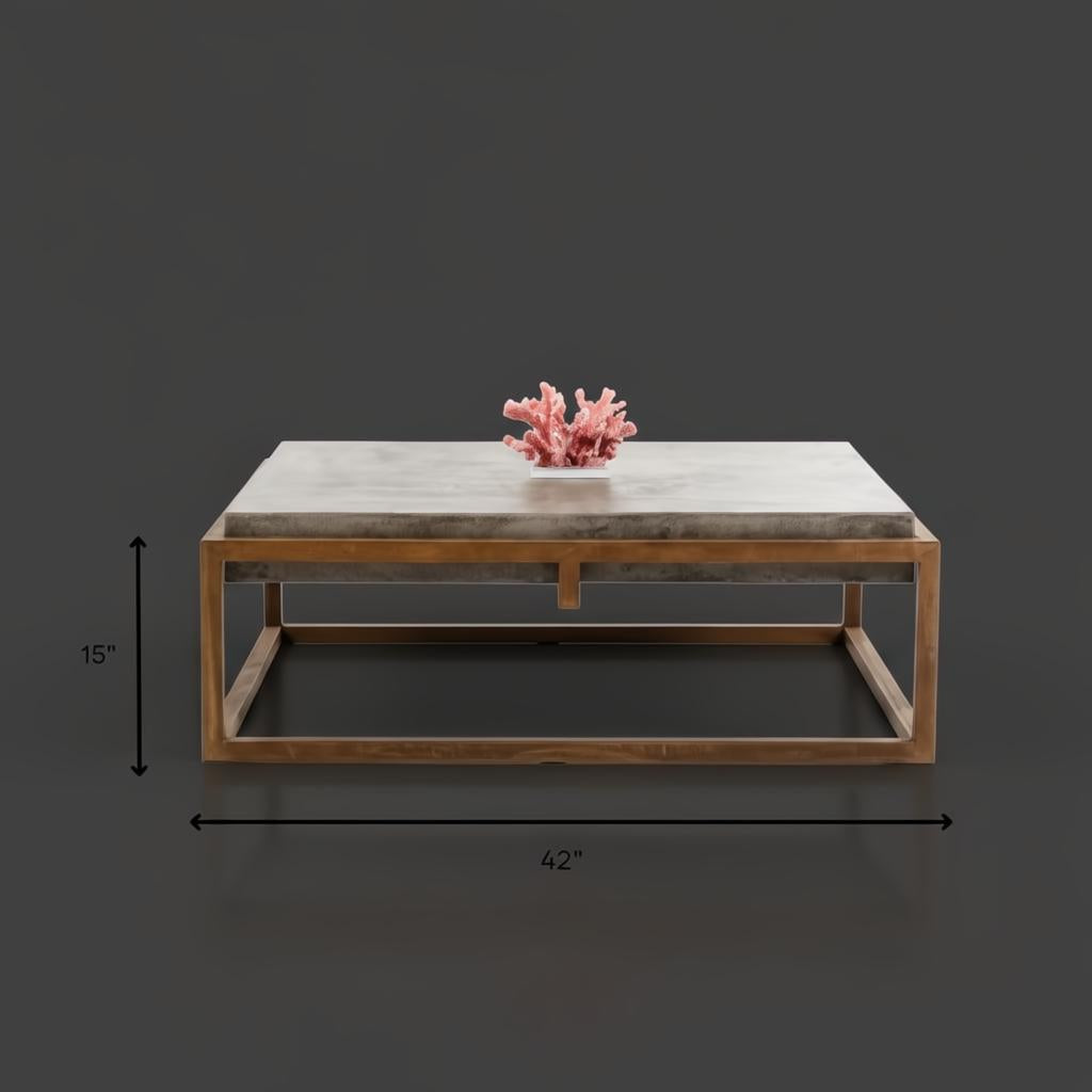 Industrial-modern concrete coffee table with a sleek metal frame, 42" wide and 15" high.