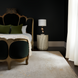 Surya Antalya AAT-2301 transitional wool area rug in a light neutral tone, complementing a dark bedroom.