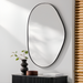 Surya Aamnah AMH-002 wall mirror with an organic, irregular shape and a sleek black iron frame.
