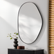 Surya Aamnah AMH-002 wall mirror with an organic, irregular shape and a sleek black iron frame.