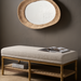 Surya Landi Bench, a brown rubber wood bench with a light beige upholstered top and woven rattan shelf.
